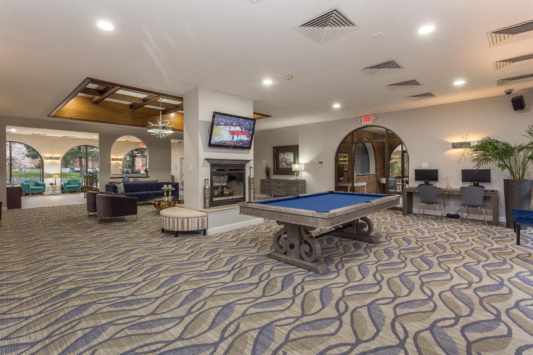 Club house furnished with television set, pool table, and seating.